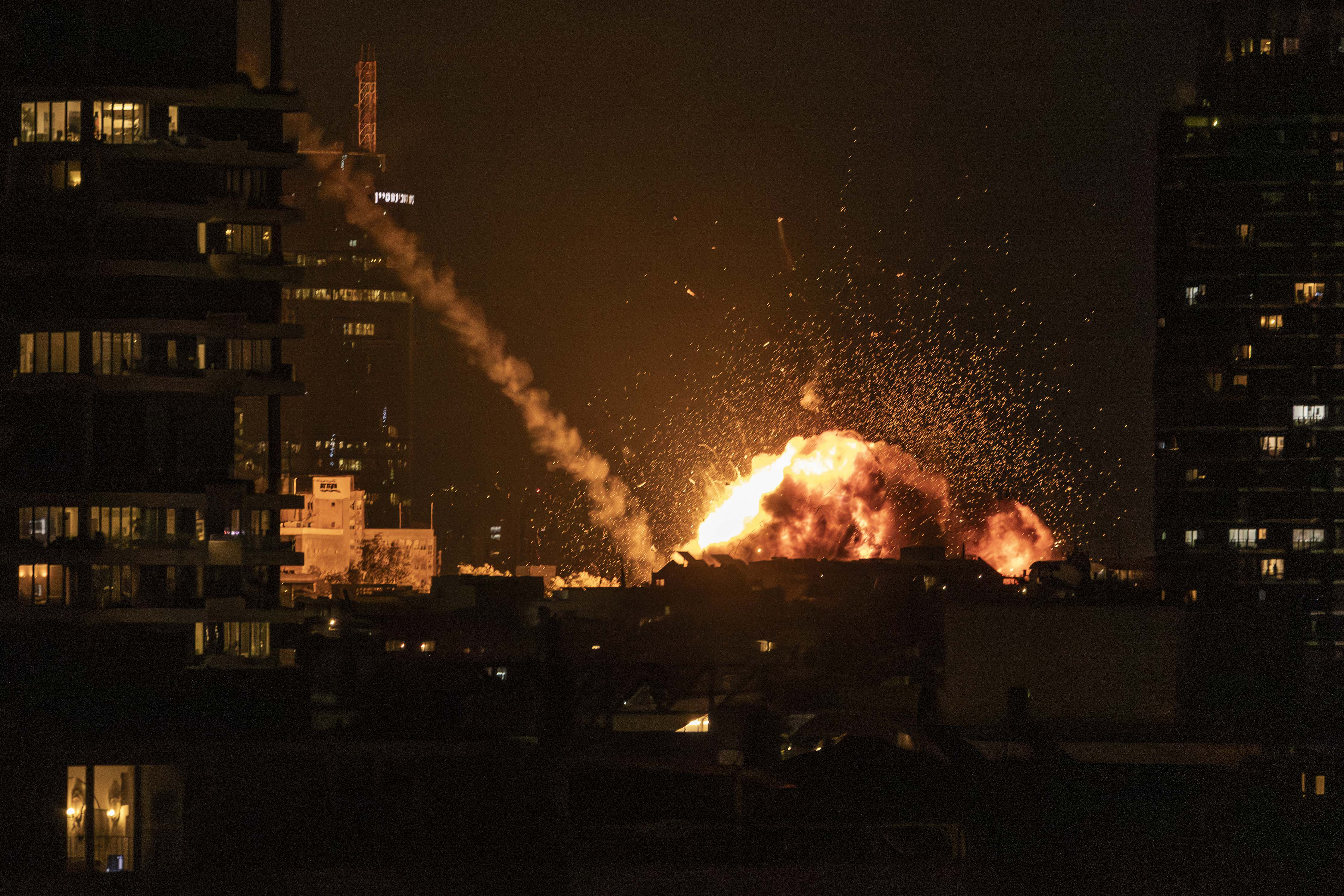 A fireball lights the sky following a missile strike on Tel Aviv